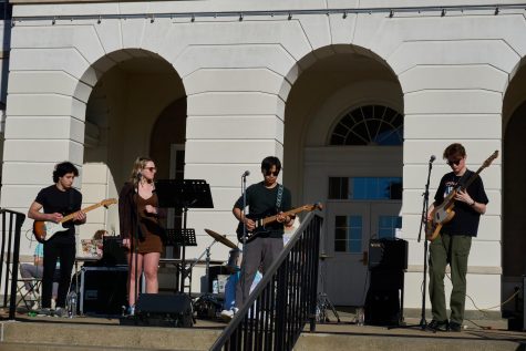 (Left to Right) Daniel Tyebkhan 23, Olivia Brand 23, Vu Le 23, Cray Case 25 (in the back), and Max Taylor 23  perform in front of the Schaffer Library Plaza. They are known as Common Interest, and they deliberately chose songs that have a sustainability-related message.