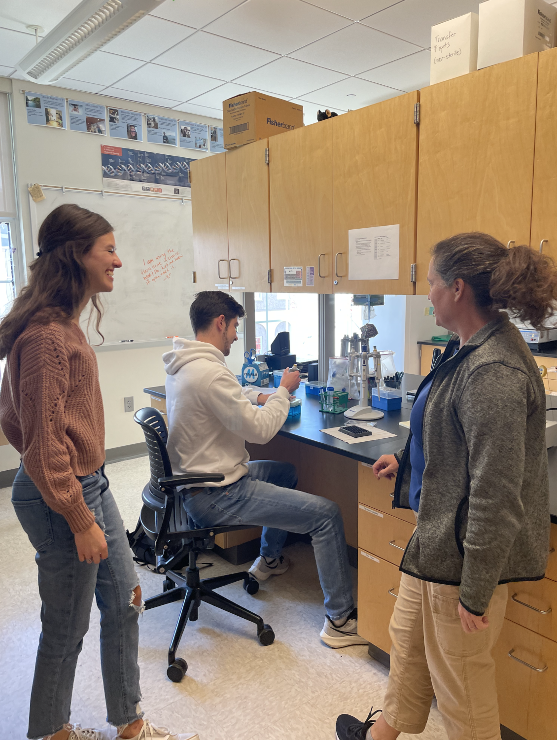 Morgan Tuesdell ‘24 (left) and Luke Miranda ‘23 (back) are research assistants to Professor Kristin Fox (right). They are working on independent projects.