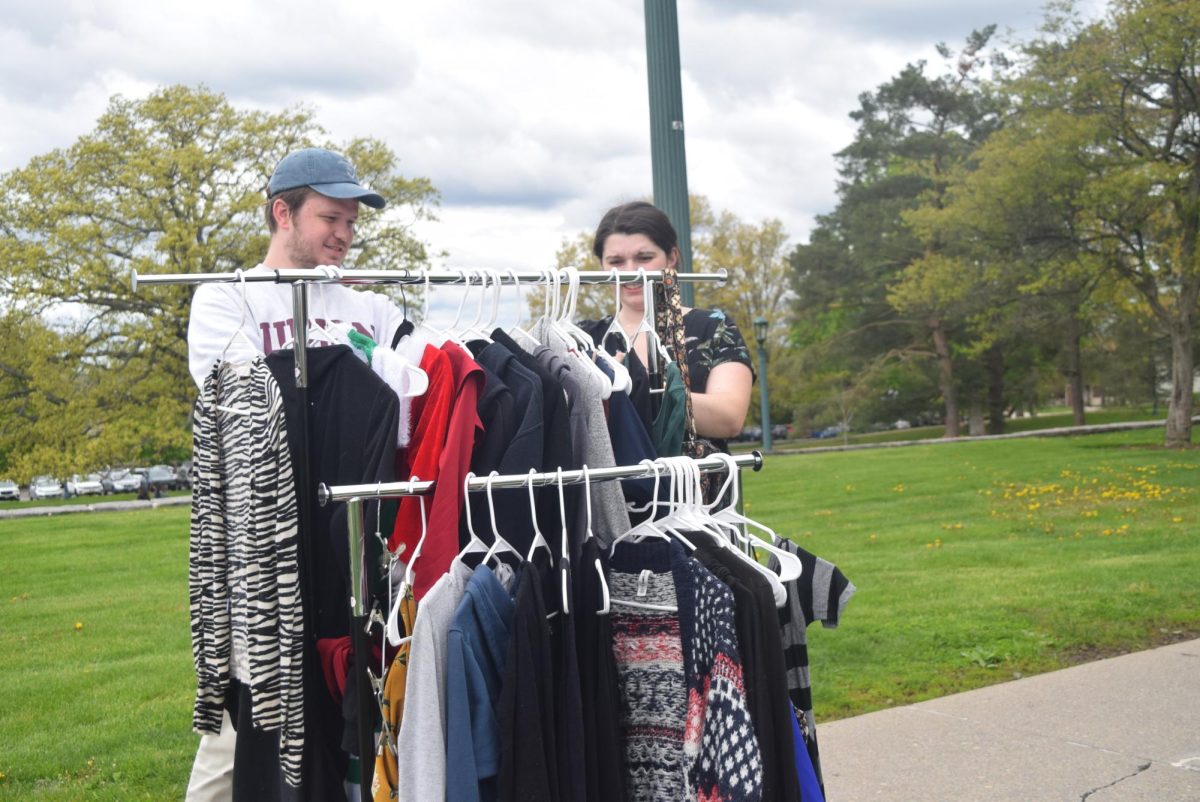 Ollie Taylor ‘24 (left) and Lane ‘23 look at clothes at the giveaway.