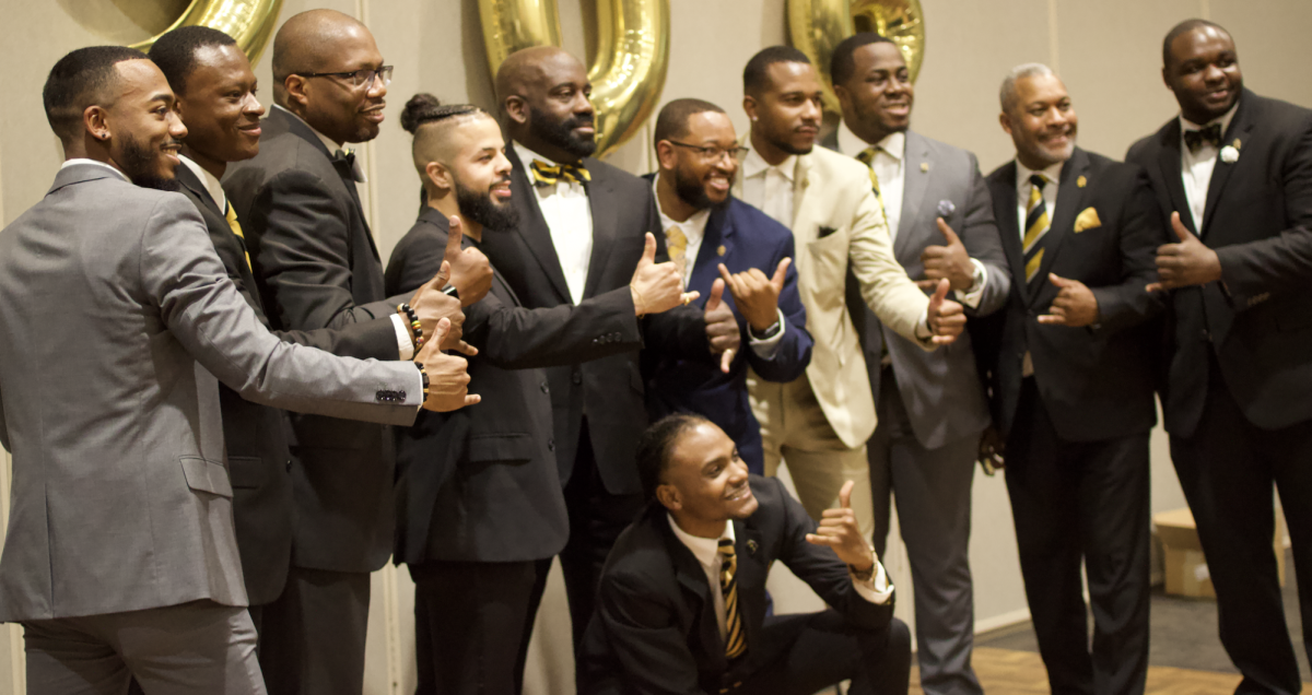 Current brothers and alumni gathering at the Black & Gold Gala.