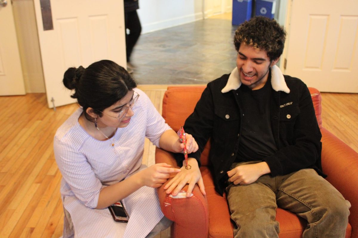 Students giving one another Henna tattoos at the event. 