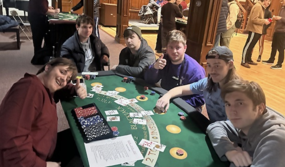 Students playing an intense game of poker. 
