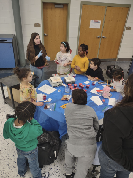 Sophia Pappas 25 works with local children at their STEM Saturday event.