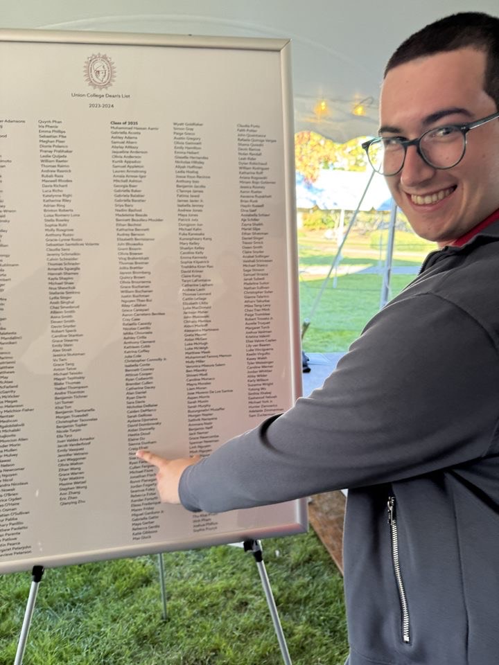 Staff writer Craig Efrati ‘25 pointing to his name on the 2023-2024 dean’s list.