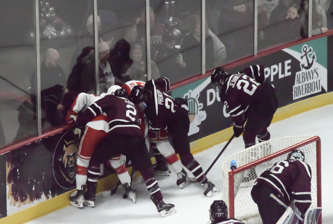 Union and RPI fighting for the puck behind Union’s goal.