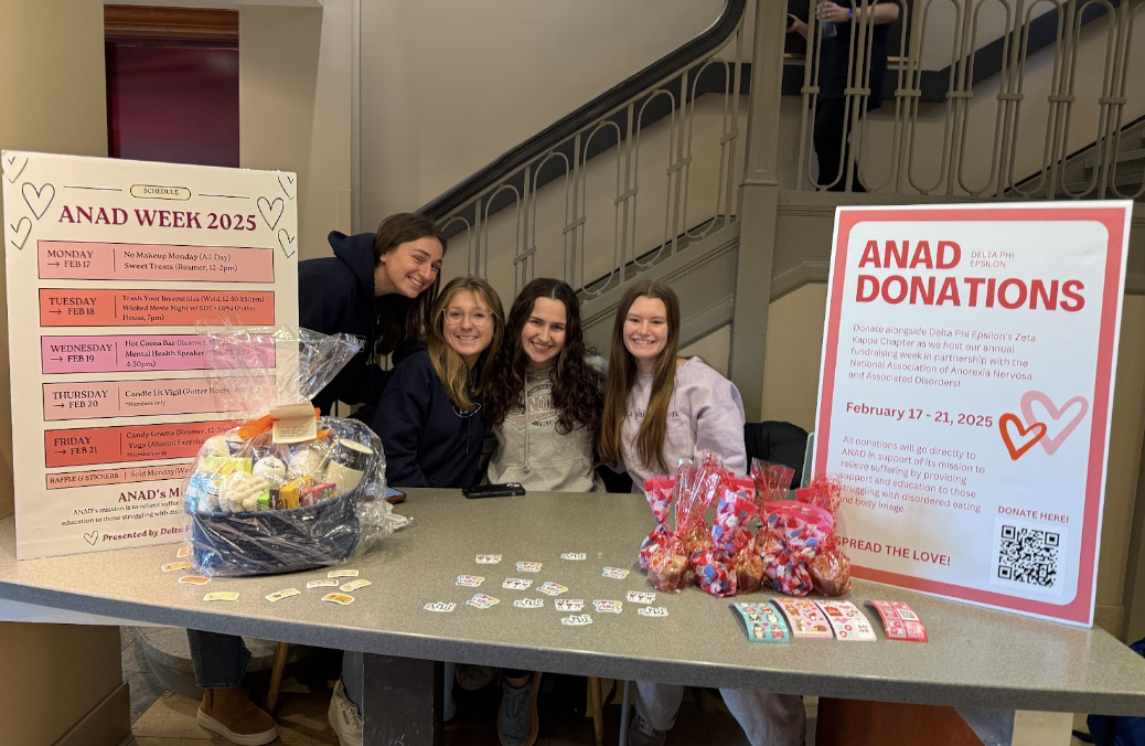 Delta Phi Epsilon members tabling in Reamer, selling raffle tickets and sweet treats. 