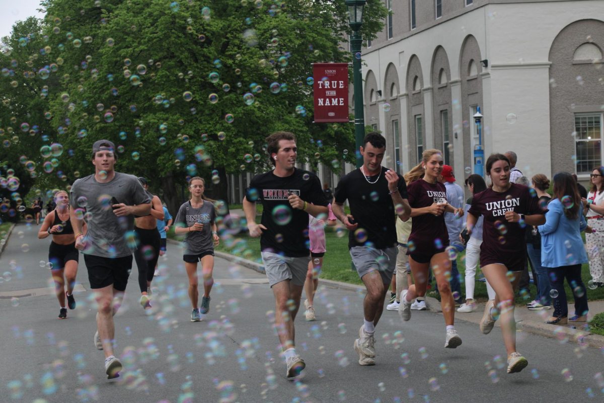 Students cross the finish line of the running portion the Run, Ribs, and Reggae event. 