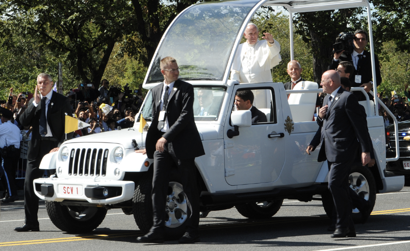 Pope Francis waving from the Popemobile.