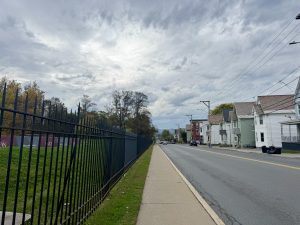 The sidewalk dividing campus gates and Schenectady residents.