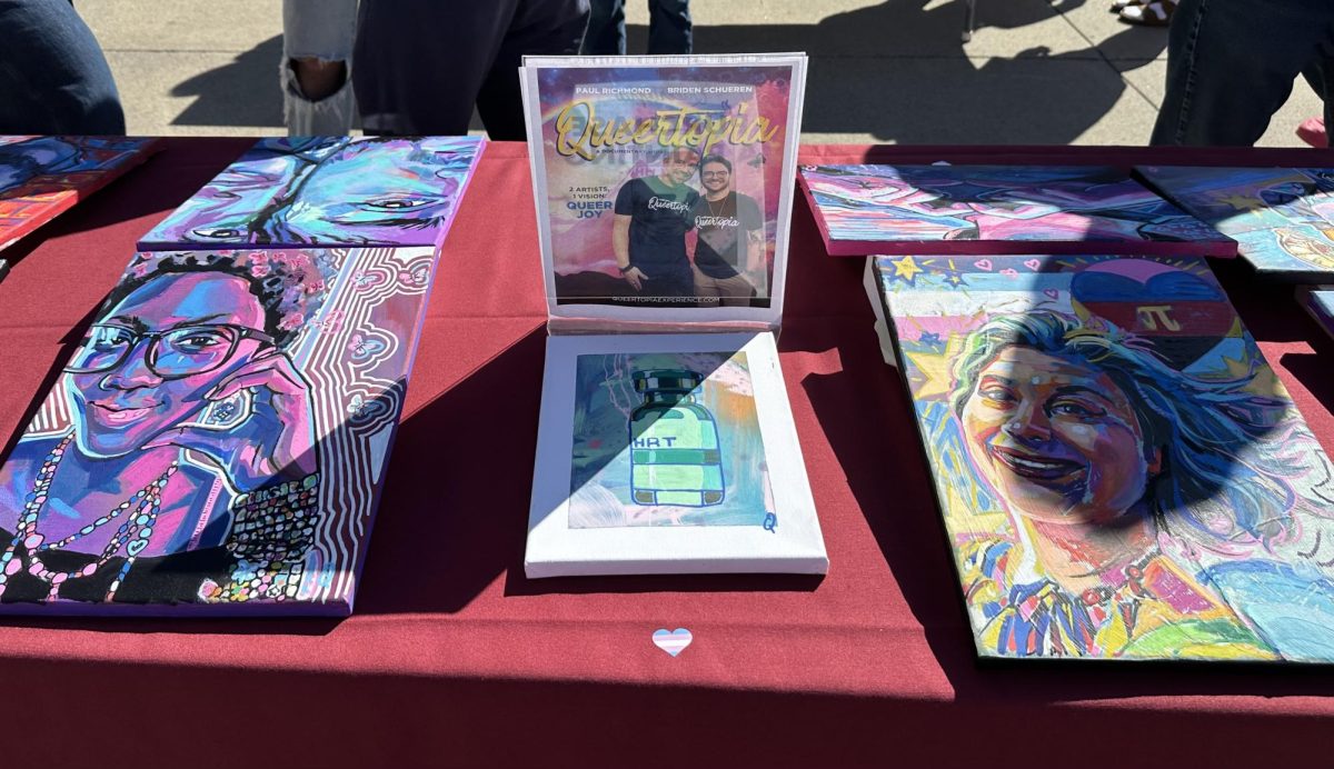 Queertopia art and flyer on display at the gallery pop-up. 