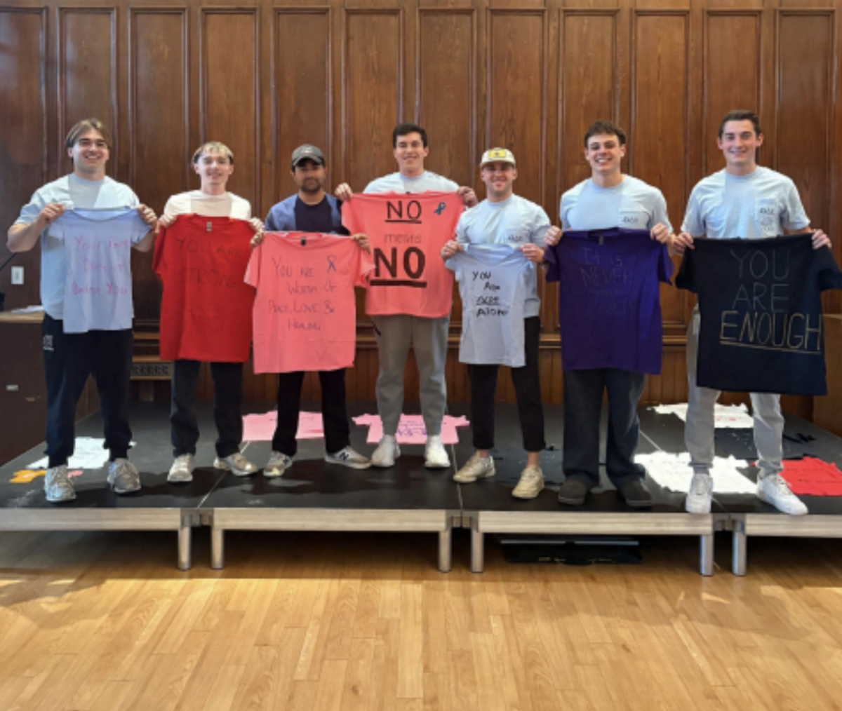 Theta Delta Chi brothers participating in the Clothesline Project. 