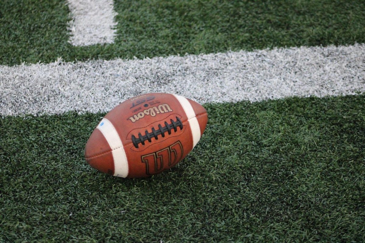 A football sits on the sidelines at a Union men’s football game.